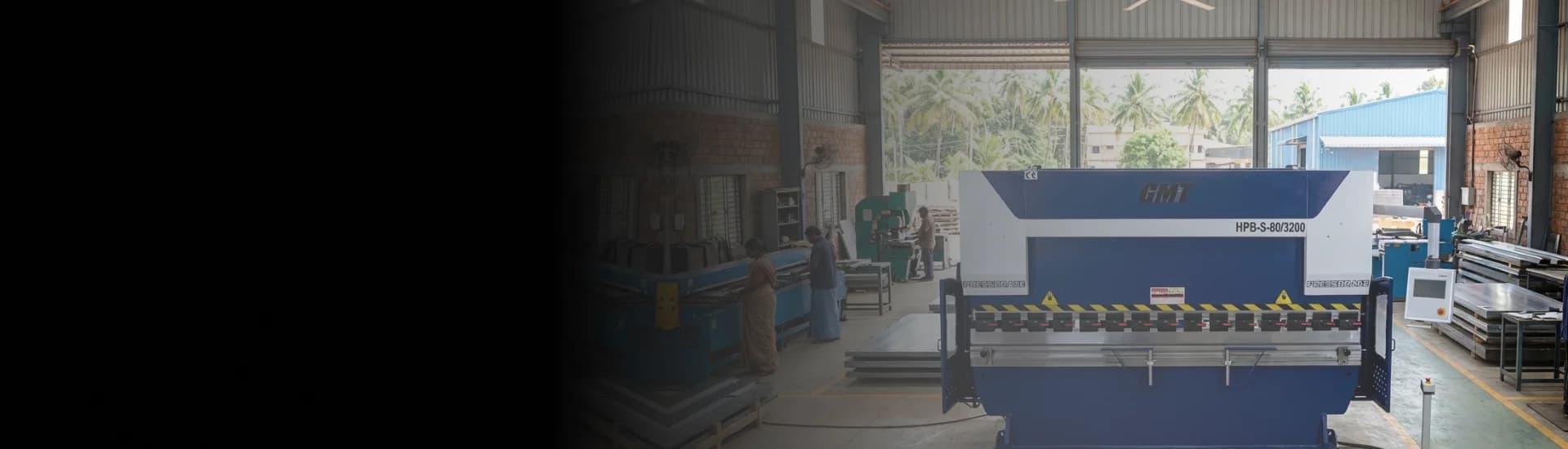 NC Press Brake machine performing heavy-duty metal bending on a factory floor.