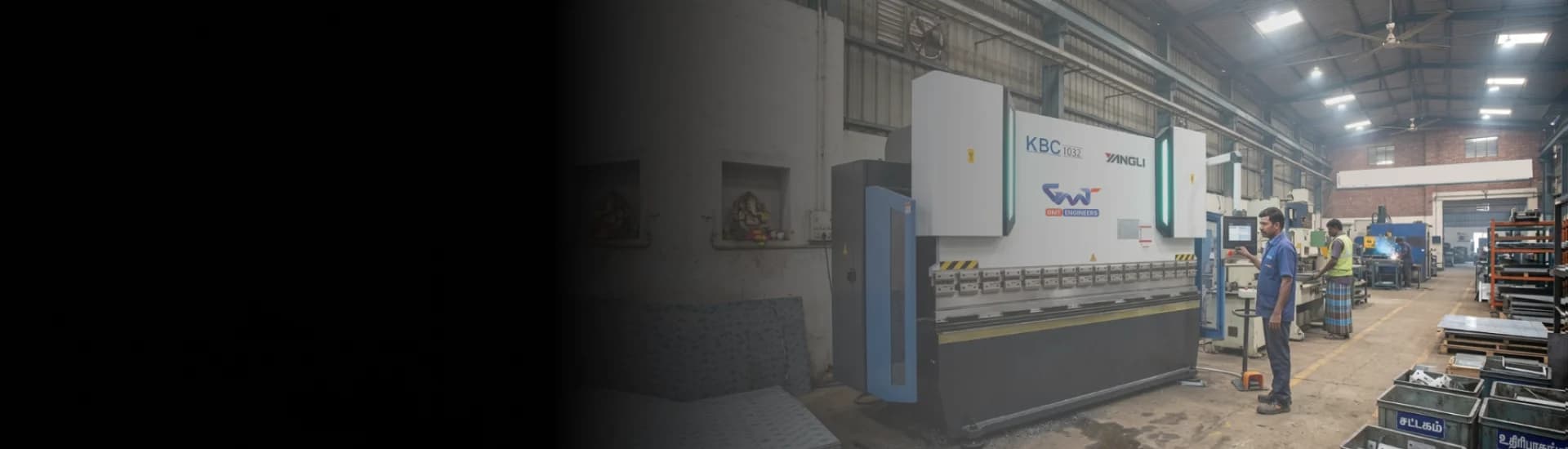 CNC Press Brake machine bending precision metal components on a factory floor.